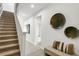 Elegant staircase with carpeted steps, leading to the upper level, complemented by stylish wall decor at 2497 Orange Harvest Pl, Seffner, FL 33584