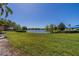 Scenic backyard overlooking a tranquil lake, offering serene views and a peaceful environment at 2720 Lancaster Dr, Sun City Center, FL 33573