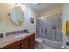 Bathroom featuring a granite vanity, toilet, and tub with sliding glass door at 2720 Lancaster Dr, Sun City Center, FL 33573