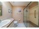 Full bathroom with granite-topped vanity, toilet, and large glass shower enclosure at 2720 Lancaster Dr, Sun City Center, FL 33573