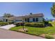 Charming home featuring a well-manicured lawn and mature landscaping, enhancing its curb appeal at 2720 Lancaster Dr, Sun City Center, FL 33573