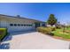 Charming single-story home with an attached garage and a well-manicured lawn at 2720 Lancaster Dr, Sun City Center, FL 33573
