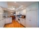 Modern kitchen with white cabinets, granite countertops, and stainless steel appliances, adjacent to dining area at 2720 Lancaster Dr, Sun City Center, FL 33573