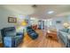 Open-concept living room with hardwood floors, comfortable seating, and lots of natural light at 2720 Lancaster Dr, Sun City Center, FL 33573