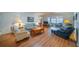 Cozy living room featuring hardwood floors, comfortable seating, and plenty of natural light at 2720 Lancaster Dr, Sun City Center, FL 33573