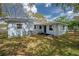 Backyard view of house, featuring green landscaping and the home's exterior at 2918 W Ellis Dr, Tampa, FL 33611
