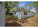Backyard view of house, featuring green landscaping and the home's exterior at 2918 W Ellis Dr, Tampa, FL 33611