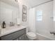 Clean, bright bathroom with gray vanity, tub with shower, and elegant wall art at 2918 W Ellis Dr, Tampa, FL 33611