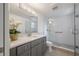 Modern bathroom with glass shower, gray vanity, and stylish fixtures at 2918 W Ellis Dr, Tampa, FL 33611