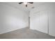 A serene bedroom with a ceiling fan, carpeted floors, and a closet with sliding doors at 2918 W Ellis Dr, Tampa, FL 33611