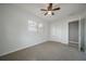 Bedroom featuring a ceiling fan, closet, neutral walls, plush carpet and natural light at 2918 W Ellis Dr, Tampa, FL 33611