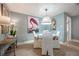 Cozy dining area with a round table, cushioned chairs, and a flamingo art piece at 2918 W Ellis Dr, Tampa, FL 33611