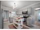 Modern kitchen with stainless steel appliances, gray cabinets, and a movable island at 2918 W Ellis Dr, Tampa, FL 33611