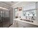 Updated kitchen with stainless steel appliances, and light-colored countertops at 2918 W Ellis Dr, Tampa, FL 33611