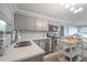 Bright kitchen featuring stainless steel appliances, gray cabinetry, and a butcher block island at 2918 W Ellis Dr, Tampa, FL 33611