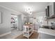 Open concept view of updated kitchen with kitchen island looking into living area at 2918 W Ellis Dr, Tampa, FL 33611