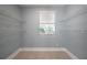 Empty walk-in closet featuring white shelving and a window at 2918 W Ellis Dr, Tampa, FL 33611