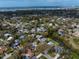 Aerial view showcasing a neighborhood with waterfront properties, lush trees, and scenic waterways at 3059 Hickory Dr, Largo, FL 33770