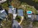 Aerial view of a home with a large backyard, fire pit, waterside access, and proximity to neighboring properties at 3059 Hickory Dr, Largo, FL 33770