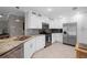 Bright kitchen featuring white cabinetry, stainless appliances, granite countertops, and mosaic backsplash at 3059 Hickory Dr, Largo, FL 33770