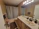 Neutral bathroom with light countertops, bathtub with shower, and standard-sized mirror at 310 Kensington Lake Cir, Brandon, FL 33511