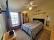 Bedroom with large bed, window, ceiling fan, and dresser set at 310 Kensington Lake Cir, Brandon, FL 33511