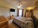 Comfortable bedroom with large bed, ceiling fan, and dresser set at 310 Kensington Lake Cir, Brandon, FL 33511