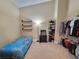 Comfortable bedroom featuring a bed, lamp, shelves, and clothing rack at 310 Kensington Lake Cir, Brandon, FL 33511