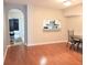 Hardwood floors in the dining area adjacent to the kitchen with an open serving bar at 310 Kensington Lake Cir, Brandon, FL 33511