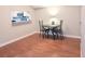 Cozy dining area with hardwood floors, table, and chairs by the kitchen serving bar at 310 Kensington Lake Cir, Brandon, FL 33511