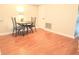 A cozy dining area with wood floors, a table with chairs, and access to other rooms at 310 Kensington Lake Cir, Brandon, FL 33511