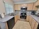Kitchen featuring stainless steel appliances, ample cabinets, and solid surface countertops at 310 Kensington Lake Cir, Brandon, FL 33511