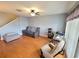 Open-concept living room with hardwood floors, comfortable seating, and a work space by the window at 310 Kensington Lake Cir, Brandon, FL 33511