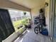 Relaxing tiled patio with outdoor plants, furniture, and green backyard views at 310 Kensington Lake Cir, Brandon, FL 33511