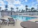 Well-maintained community pool with sun loungers, tables, and a view of palm trees at 310 Kensington Lake Cir, Brandon, FL 33511