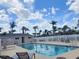 Community pool featuring lounge seating, picnic tables, and a clean, refreshing appearance at 310 Kensington Lake Cir, Brandon, FL 33511
