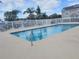 Community pool with a fenced perimeter and plenty of lounge chairs and tables for residents at 310 Kensington Lake Cir, Brandon, FL 33511