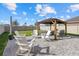 Backyard features a paved patio with a pergola and outdoor furniture, perfect for entertaining at 31386 Penny Surf Loop, Wesley Chapel, FL 33545