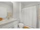 Simple bathroom featuring a shower with curtain, toilet, sink, and neutral color palette at 31386 Penny Surf Loop, Wesley Chapel, FL 33545