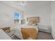 Bright bedroom featuring a bed with a decorative headboard and a window with a view at 31386 Penny Surf Loop, Wesley Chapel, FL 33545
