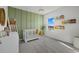 Charming Bedroom with a crib and green accent wall with custom name decor at 31386 Penny Surf Loop, Wesley Chapel, FL 33545