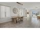Bright dining area featuring a stylish light fixture, table with bench, and seamless transition to the outdoors at 31386 Penny Surf Loop, Wesley Chapel, FL 33545