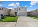 Beautiful two-story home featuring a well-manicured lawn, a two-car garage, and inviting curb appeal at 31386 Penny Surf Loop, Wesley Chapel, FL 33545