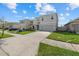 Well-maintained two-story home with a spacious driveway, neat landscaping, and a welcoming entrance at 31386 Penny Surf Loop, Wesley Chapel, FL 33545