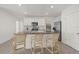Bright kitchen featuring an island with bar stools, stainless steel appliances, and a walk-in pantry at 31386 Penny Surf Loop, Wesley Chapel, FL 33545