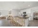 Modern kitchen features a center island with bar seating, stainless steel appliances, and ample counter space at 31386 Penny Surf Loop, Wesley Chapel, FL 33545