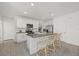 Open-concept kitchen with an island and bar seating, stainless appliances, and well-lit modern features at 31386 Penny Surf Loop, Wesley Chapel, FL 33545