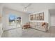 Inviting living room features tile floors, a comfortable sectional, and sliding glass doors at 31386 Penny Surf Loop, Wesley Chapel, FL 33545