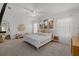 Spacious main bedroom showcasing neutral carpet, natural light, and an inviting bed at 31386 Penny Surf Loop, Wesley Chapel, FL 33545