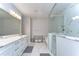 This luxurious bathroom features marble floors, a double vanity, and a glass enclosed shower and tub at 3215 W De Leon St # 6, Tampa, FL 33609